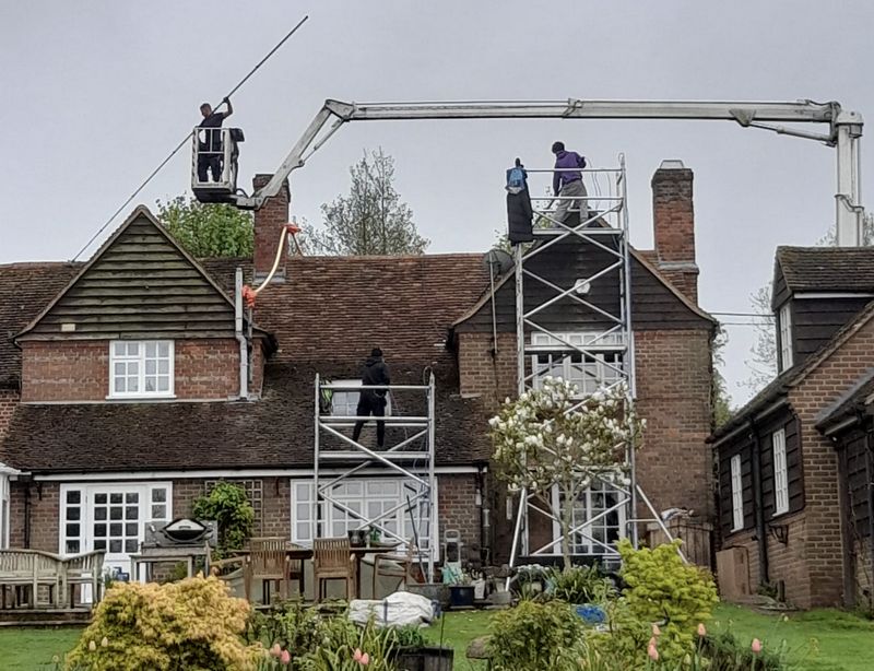 The Roof Moss Cleaners using cherry picker and scaffolding to clean roof safely and professionally in Earls Barton, Northamptonshire